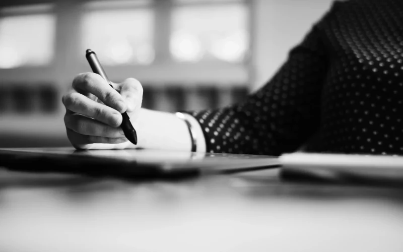 best freelance content writer in kerala writing on a book
